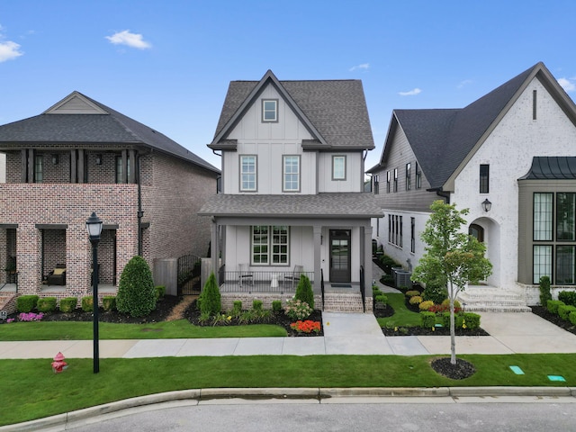 view of front of property featuring a front yard, covered porch, and central air condition unit