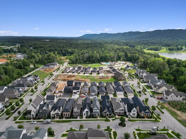 birds eye view of property with a water and mountain view