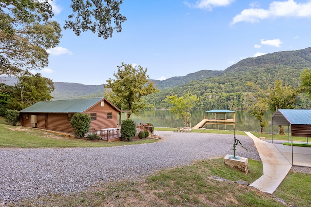 exterior space with a water and mountain view