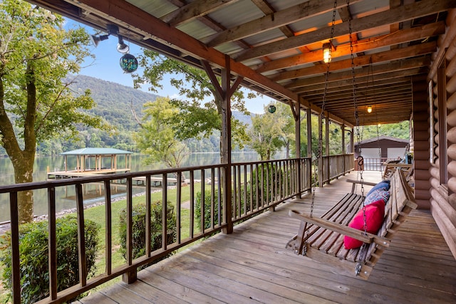 deck with a water and mountain view