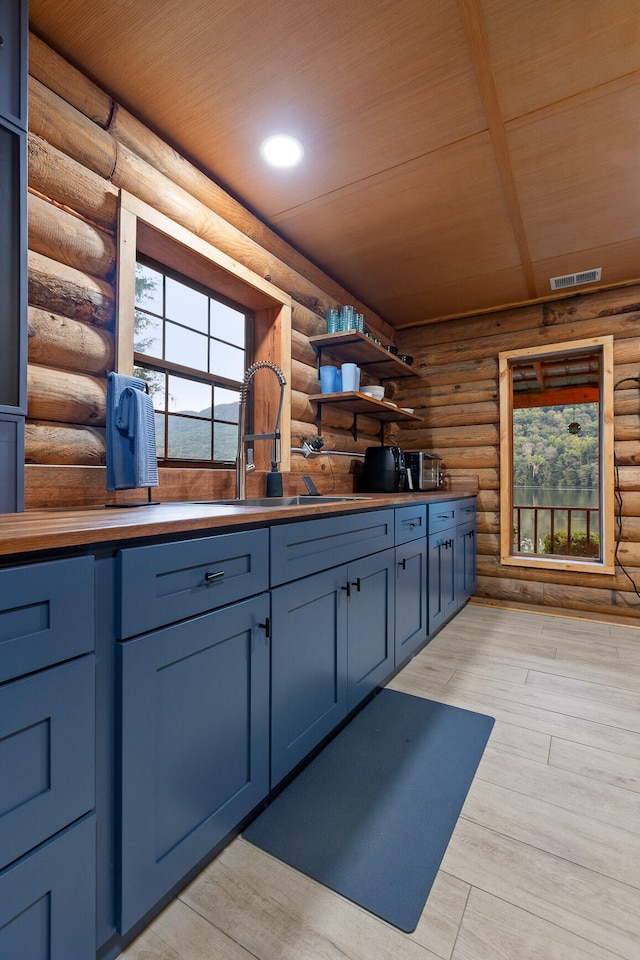 bathroom featuring sink, log walls, wood ceiling, and hardwood / wood-style flooring