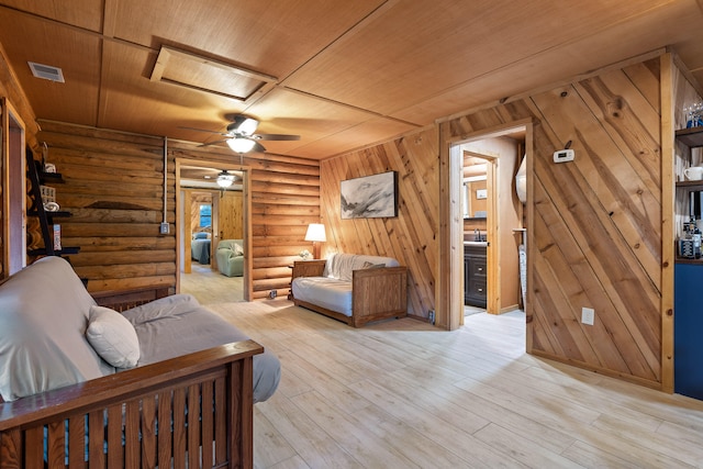 living room with wood ceiling, rustic walls, ceiling fan, and light hardwood / wood-style floors