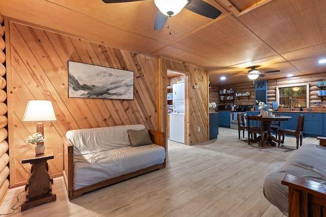 living room featuring light wood-type flooring, wooden ceiling, and wooden walls