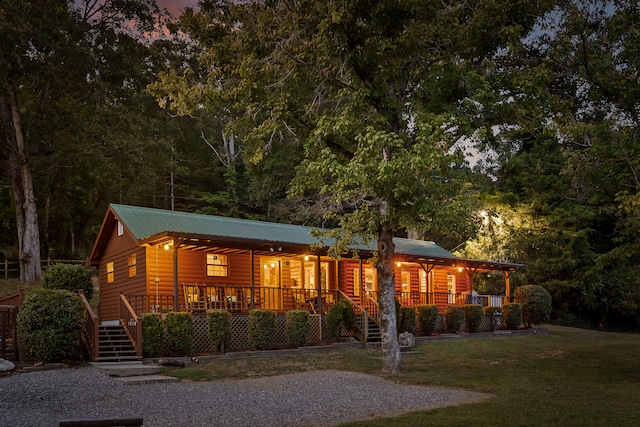 log home with a yard and a porch