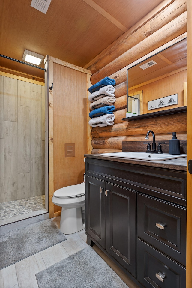 bathroom with log walls, wooden ceiling, wood-type flooring, toilet, and vanity