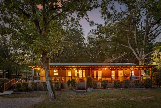 log-style house featuring covered porch