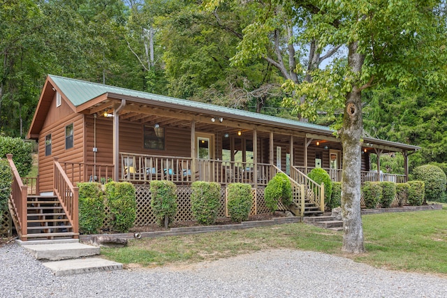 log home featuring covered porch