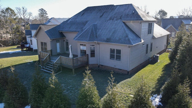 back of property featuring central air condition unit, a yard, and a wooden deck