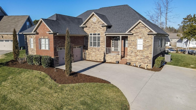 craftsman house with a front lawn and a garage