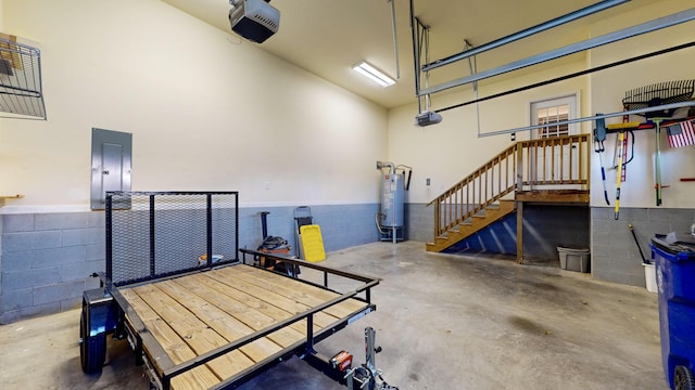 garage with a garage door opener, electric panel, and gas water heater