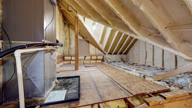 unfinished attic featuring heating unit