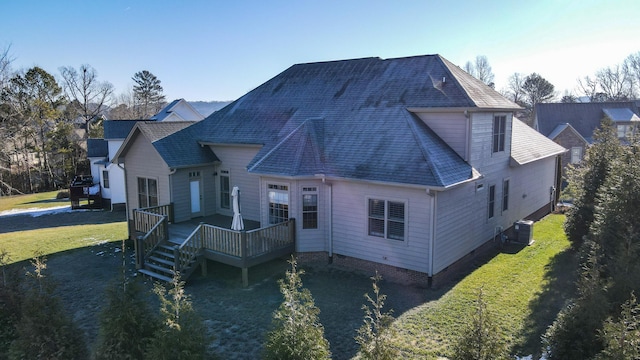 exterior space featuring a wooden deck and a lawn