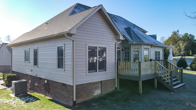 back of house featuring a deck and central AC unit