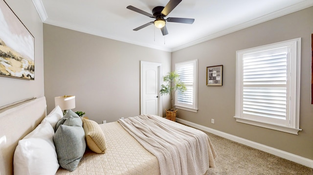 carpeted bedroom featuring ceiling fan and crown molding