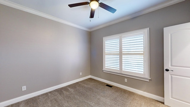 carpeted empty room featuring ceiling fan and crown molding