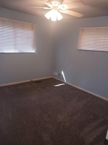 empty room with carpet and ceiling fan