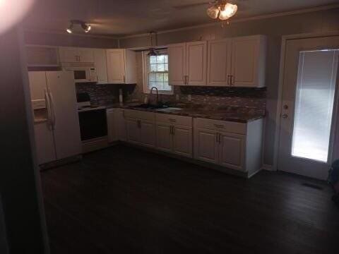 kitchen featuring tasteful backsplash, sink, dark wood-type flooring, and white appliances