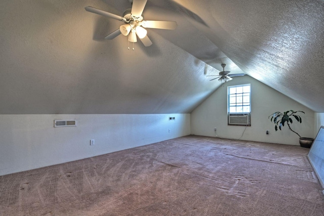 additional living space featuring ceiling fan, carpet floors, and a textured ceiling