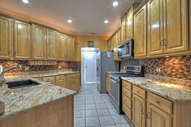 kitchen with sink, light stone counters, appliances with stainless steel finishes, light tile patterned floors, and ornamental molding