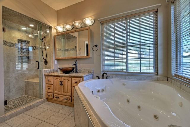 bathroom with tile patterned flooring, shower with separate bathtub, and vanity