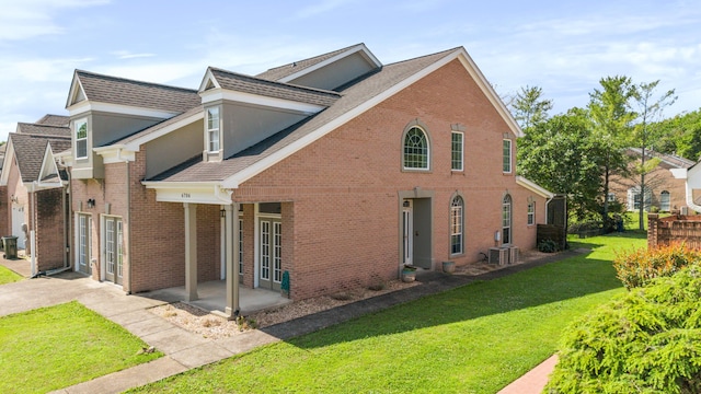 6706 Willow Trace Dr, Chattanooga, TN 37421 - view of property exterior featuring a yard, brick siding, a shingled roof, and central AC unit