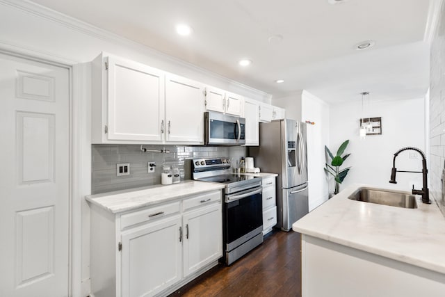 6706 Willow Trace Dr, Chattanooga, TN 37421 - kitchen featuring appliances with stainless steel finishes, a sink, ornamental molding, tasteful backsplash, and white cabinetry