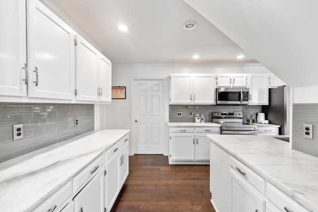 6706 Willow Trace Dr, Chattanooga, TN 37421 - kitchen featuring appliances with stainless steel finishes, decorative backsplash, white cabinets, crown molding, and recessed lighting