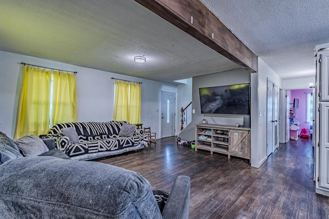 living room with a textured ceiling, stairway, and wood finished floors