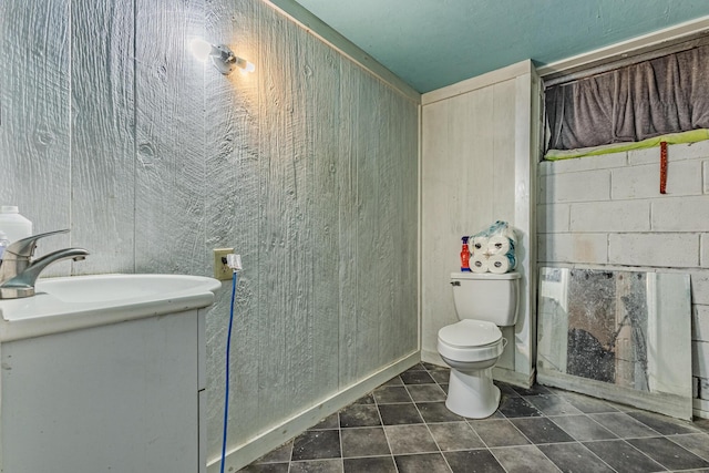 bathroom with toilet, tile patterned flooring, and vanity