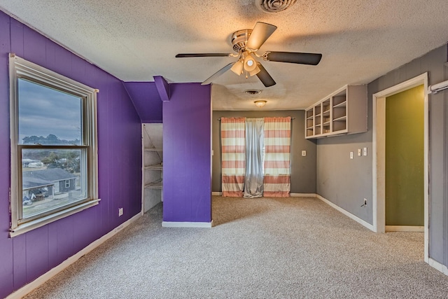 unfurnished bedroom featuring carpet floors, baseboards, visible vents, and a textured ceiling