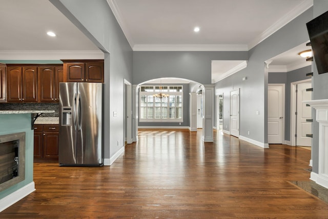 kitchen featuring backsplash, crown molding, dark hardwood / wood-style flooring, and stainless steel refrigerator with ice dispenser