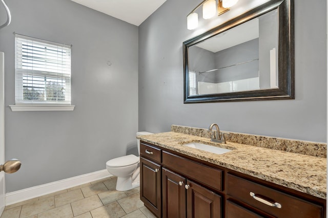 bathroom featuring tile patterned floors, vanity, toilet, and a shower