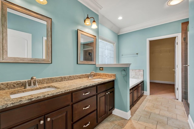 bathroom featuring tile patterned flooring, vanity, and a tub