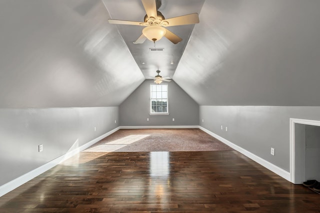 bonus room with vaulted ceiling, ceiling fan, and dark wood-type flooring