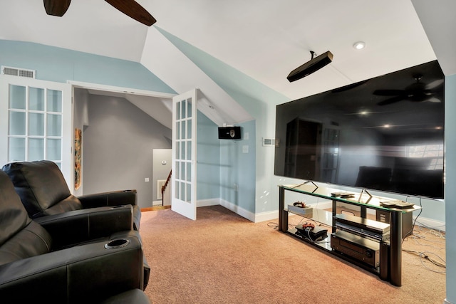 carpeted living room with ceiling fan, french doors, and vaulted ceiling