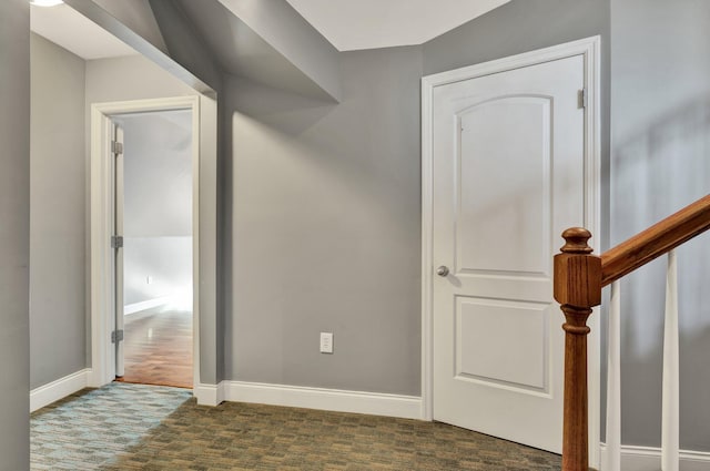 corridor with dark hardwood / wood-style flooring