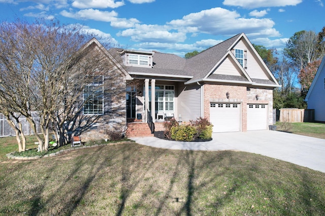 craftsman inspired home with a front lawn, covered porch, and a garage