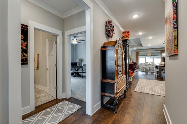 corridor featuring recessed lighting, baseboards, wood finished floors, and crown molding