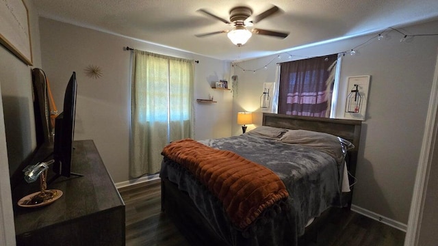 bedroom featuring dark wood-style floors, baseboards, and ceiling fan