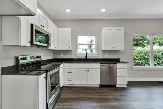 2028 Blythe Ave SE, Cleveland, TN 37311 - kitchen featuring stainless steel appliances, dark wood-style floors, white cabinets, recessed lighting, and dark stone counters