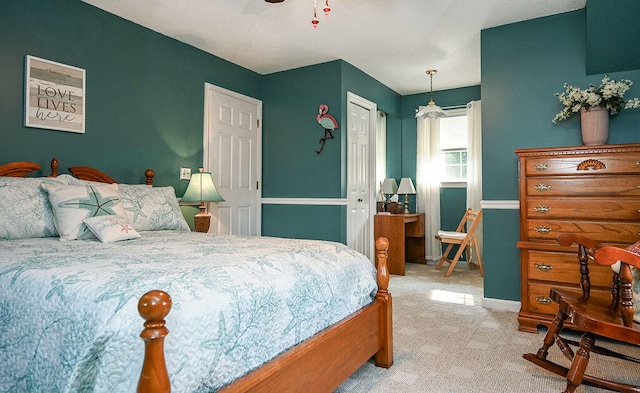 carpeted bedroom with a closet and ceiling fan