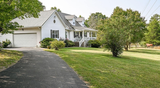 new england style home featuring a garage, a porch, and a front yard