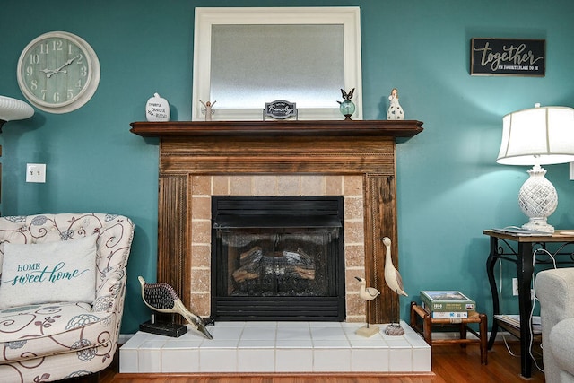 living area with wood-type flooring and a fireplace