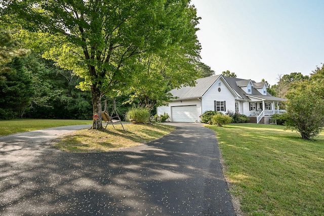 view of front of property featuring a garage and a front lawn