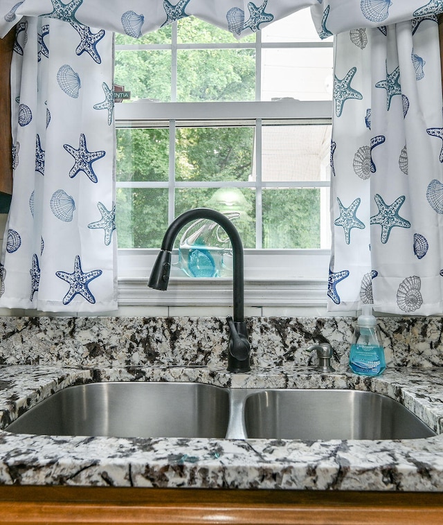 details with stone countertops and sink