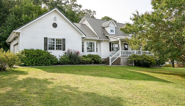 new england style home featuring a front yard and covered porch