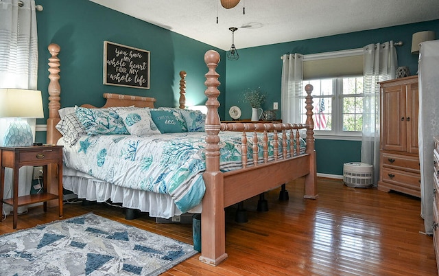 bedroom with ceiling fan and wood-type flooring