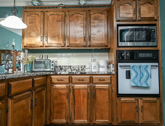 kitchen with wall oven, backsplash, ornamental molding, pendant lighting, and stainless steel microwave