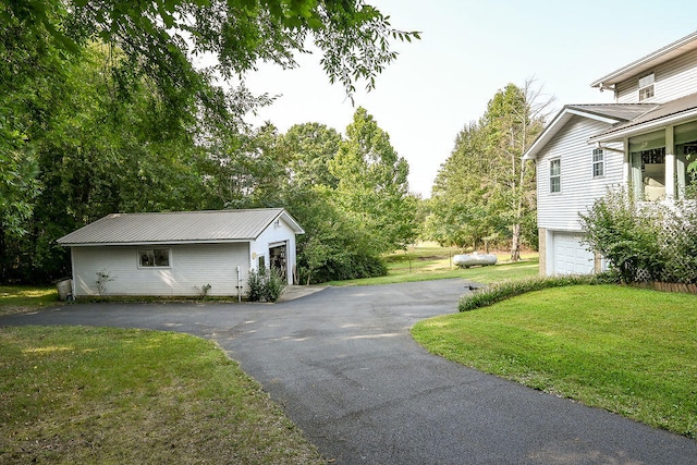 view of property exterior with a garage and a yard