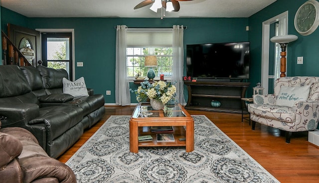 living room with hardwood / wood-style flooring and ceiling fan